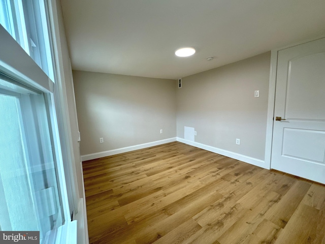 spare room with light hardwood / wood-style flooring