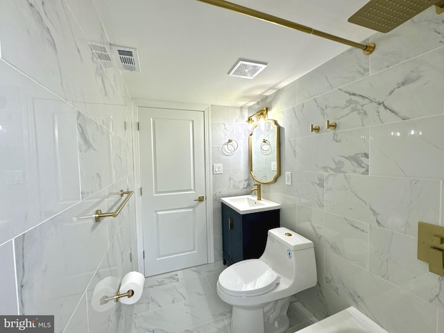 bathroom featuring toilet, vanity, tile walls, and walk in shower