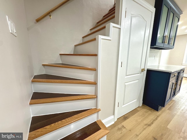 stairs featuring hardwood / wood-style flooring