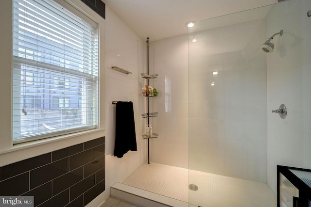 bathroom with tile walls and tiled shower