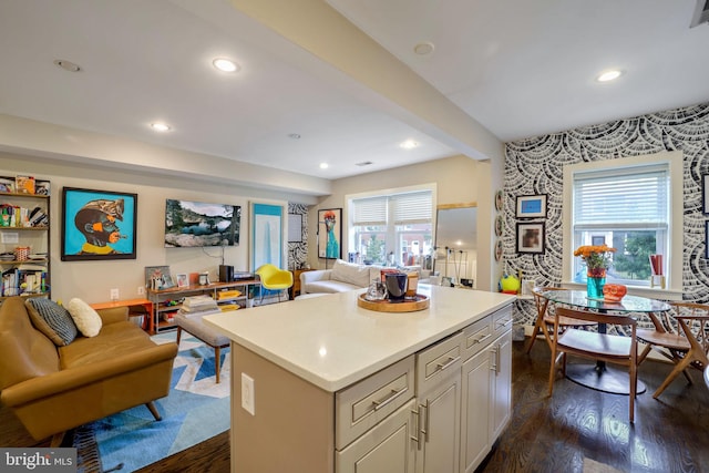 kitchen with dark hardwood / wood-style flooring, a center island, and a wealth of natural light