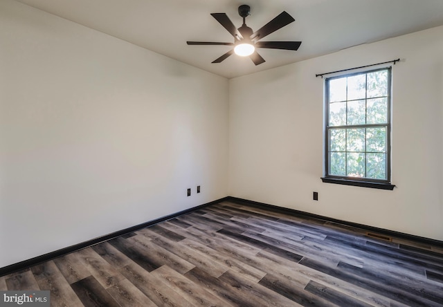 unfurnished room with dark hardwood / wood-style floors and ceiling fan