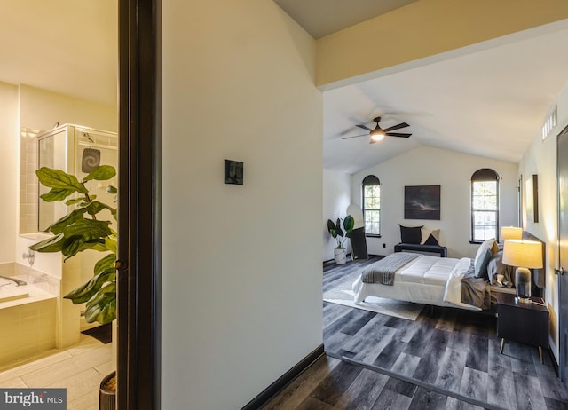 bedroom featuring connected bathroom, lofted ceiling, ceiling fan, and dark hardwood / wood-style flooring