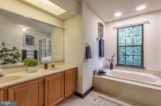 bathroom featuring vanity, independent shower and bath, and tile patterned flooring