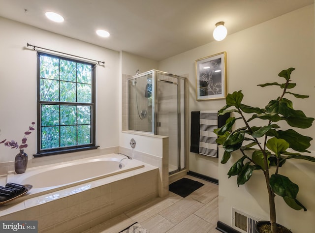 bathroom with shower with separate bathtub