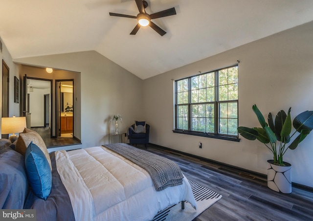 bedroom featuring connected bathroom, dark wood-type flooring, vaulted ceiling, and ceiling fan