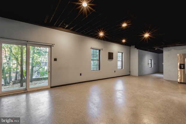 unfurnished room featuring concrete flooring