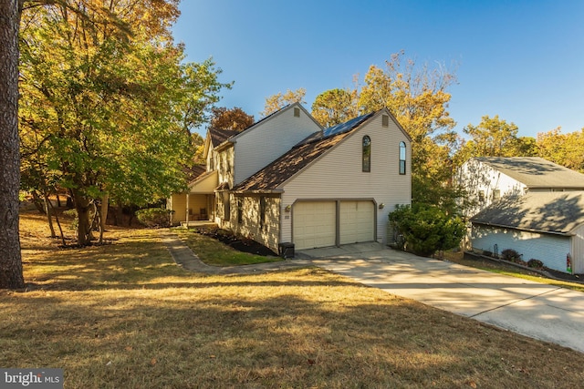 view of front of house with a garage and a front lawn