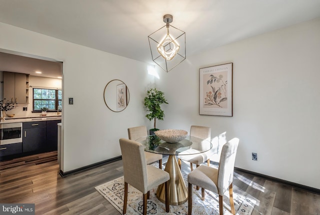 dining room with a chandelier and dark hardwood / wood-style floors