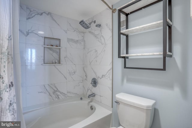 bathroom featuring shower / tub combo and toilet