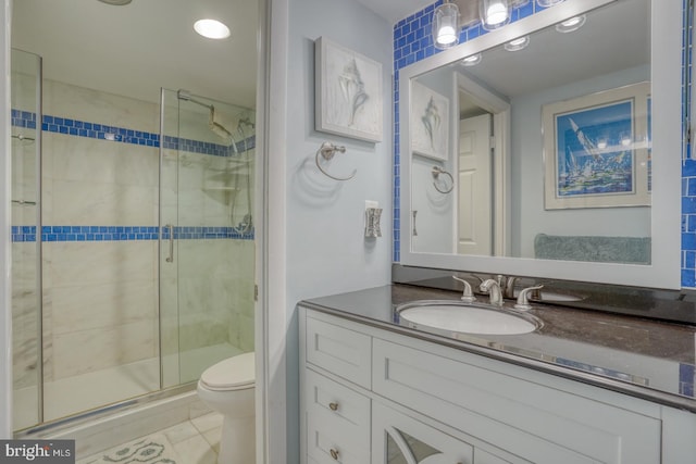 bathroom with tile patterned flooring, toilet, an enclosed shower, and vanity