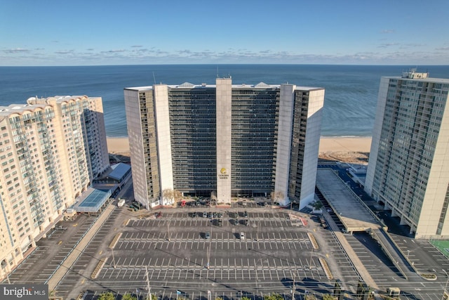 drone / aerial view with a beach view and a water view