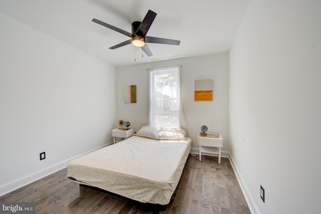 bedroom with dark hardwood / wood-style floors and ceiling fan