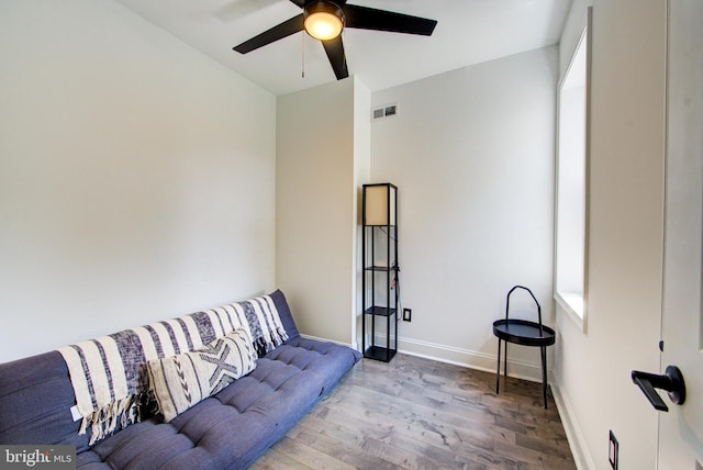 living room with hardwood / wood-style floors and ceiling fan