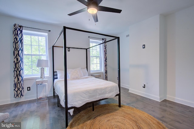 bedroom with dark hardwood / wood-style floors and ceiling fan