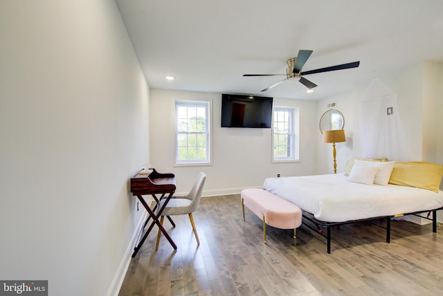 bedroom with ceiling fan and light wood-type flooring