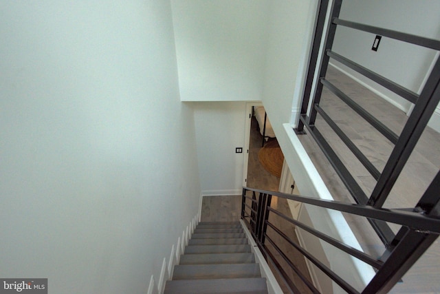 stairway with hardwood / wood-style flooring