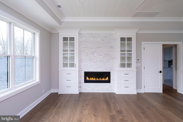unfurnished living room with dark wood-style floors, wooden ceiling, crown molding, baseboards, and a fireplace