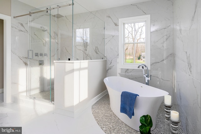 bathroom with shower with separate bathtub and tile walls