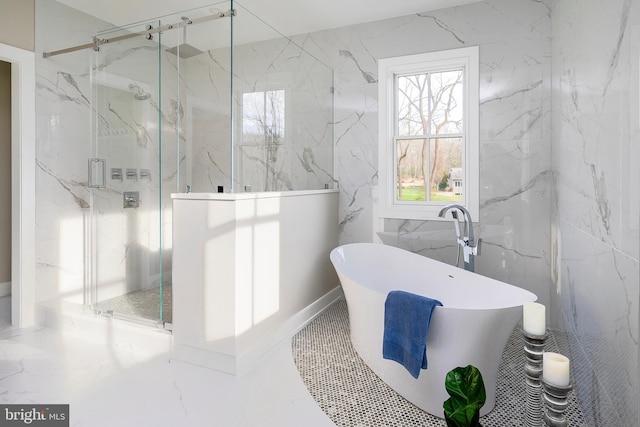 full bath with a soaking tub, a marble finish shower, and tile walls