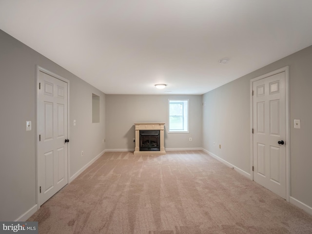 unfurnished living room with light colored carpet