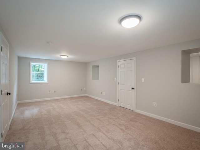 basement featuring light colored carpet