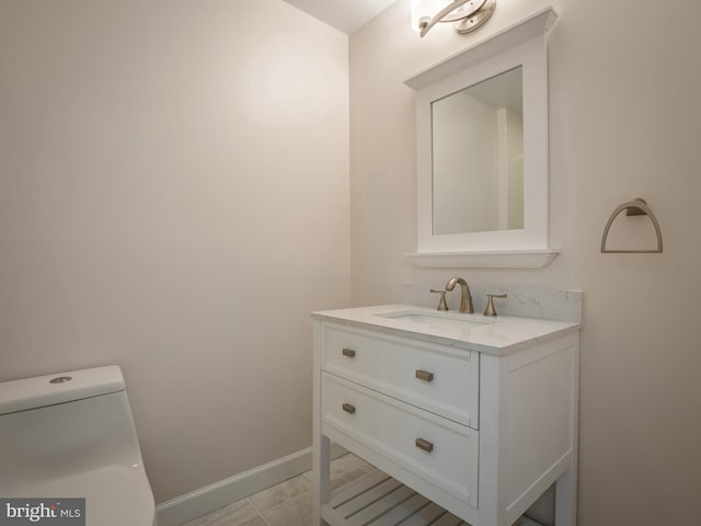 bathroom with vanity, toilet, and tile patterned flooring