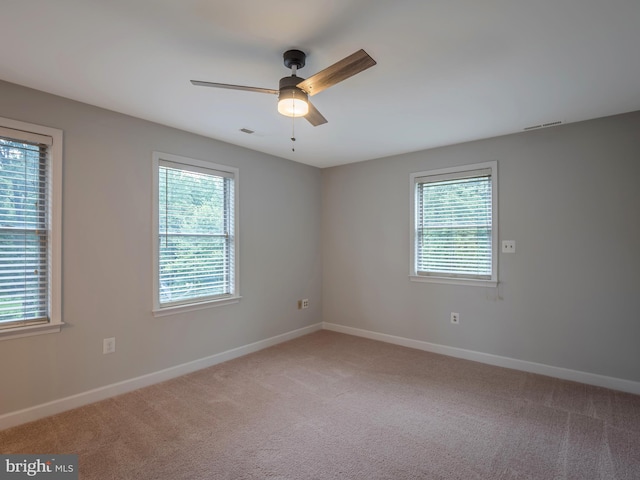 carpeted empty room with ceiling fan