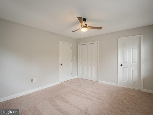 unfurnished bedroom featuring light colored carpet and ceiling fan