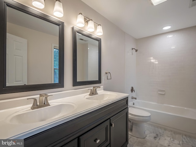 full bathroom with vanity, toilet, and tiled shower / bath