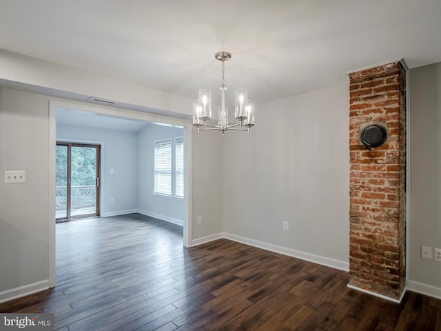 unfurnished dining area featuring dark hardwood / wood-style floors and a chandelier