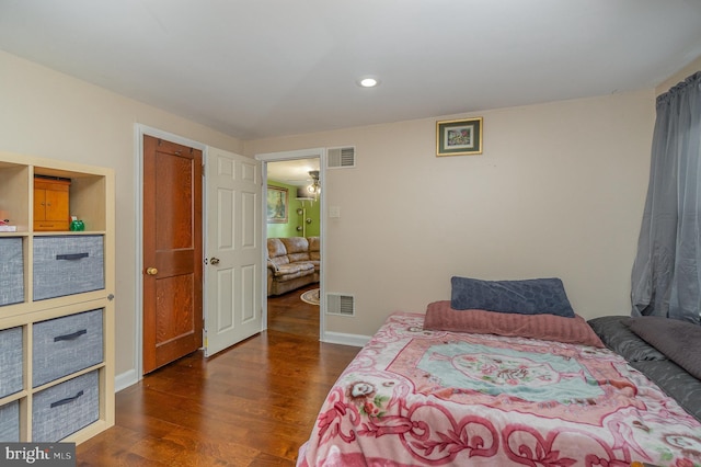 bedroom with dark hardwood / wood-style floors