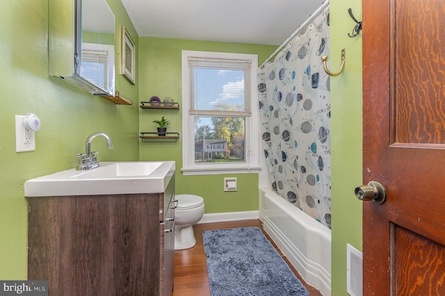 full bathroom featuring toilet, shower / bath combo, hardwood / wood-style flooring, and vanity