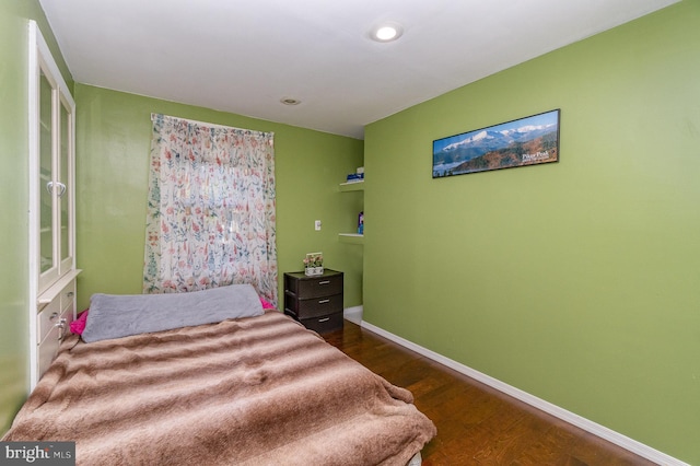 bedroom featuring dark hardwood / wood-style flooring