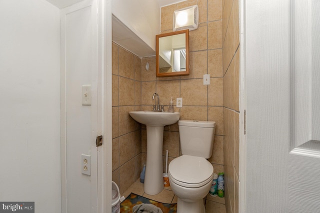 bathroom featuring tile walls, sink, toilet, and tile patterned floors