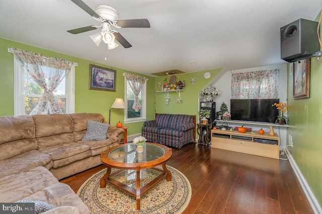 living room featuring ceiling fan and dark hardwood / wood-style flooring