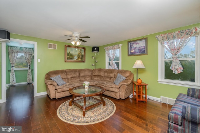 living room with dark hardwood / wood-style floors and ceiling fan