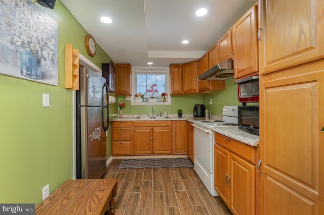 kitchen with sink, white range with electric cooktop, dark wood-type flooring, extractor fan, and stainless steel refrigerator