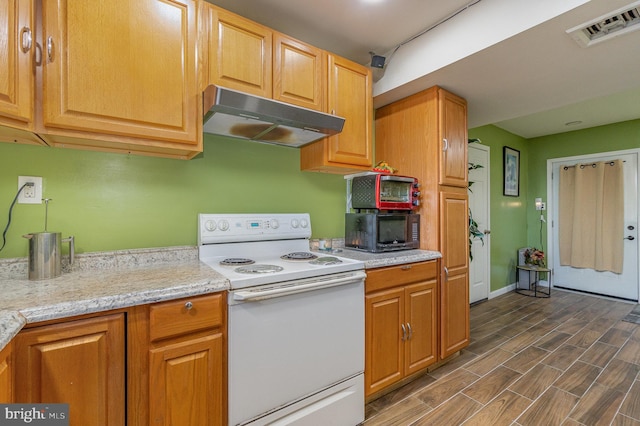 kitchen featuring light stone countertops, dark wood-type flooring, and electric stove