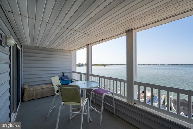 sunroom / solarium with a water view