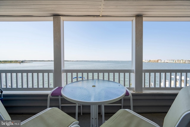 sunroom / solarium featuring a water view and plenty of natural light