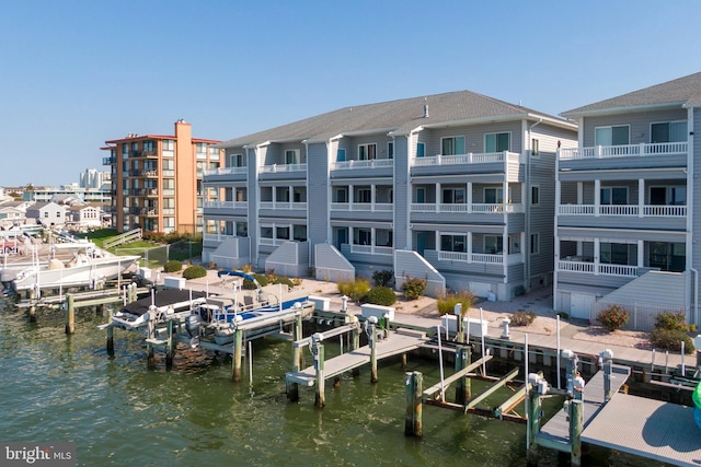 view of dock featuring a water view and a balcony