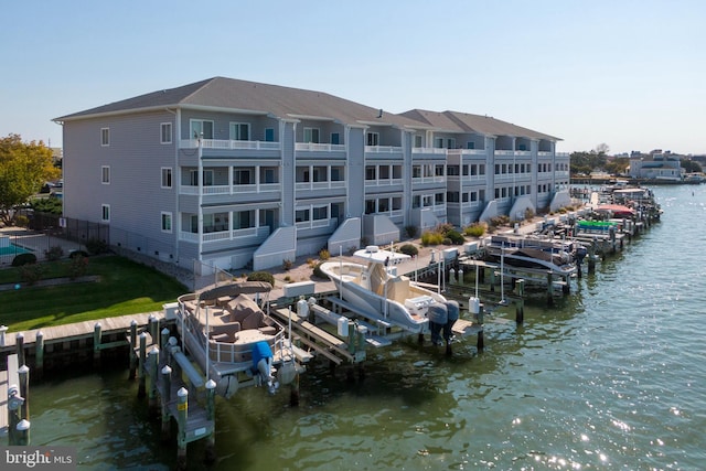 view of dock with a balcony and a water view