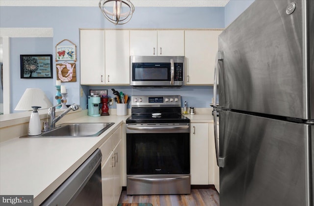 kitchen with sink, white cabinets, stainless steel appliances, and dark hardwood / wood-style floors