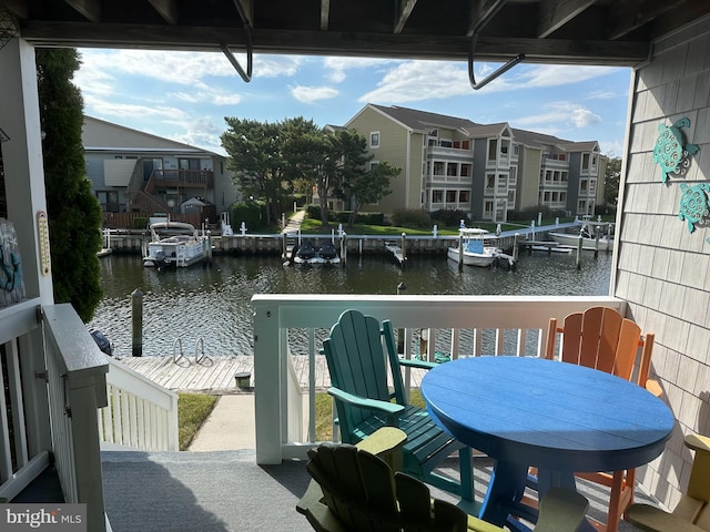 balcony featuring a dock and a water view