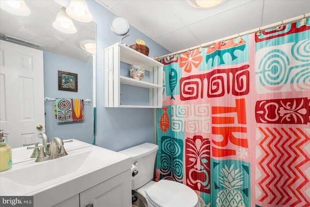 bathroom featuring vanity, curtained shower, and toilet