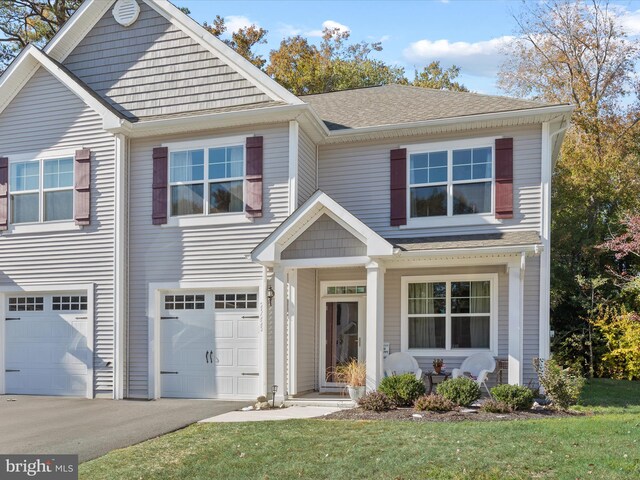 29225 Shady Creek Ln Unit 29, Dagsboro, DE 19939 - view of front facade featuring covered porch, aphalt driveway, a shingled roof, a front lawn, and an attached garage