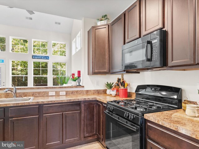 29225 Shady Creek Ln Unit 29, Dagsboro, DE 19939 - kitchen with a sink, visible vents, light countertops, dark brown cabinets, and black appliances