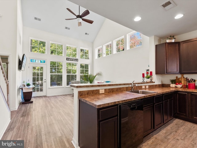 kitchen with dishwasher, light hardwood / wood-style flooring, kitchen peninsula, sink, and high vaulted ceiling