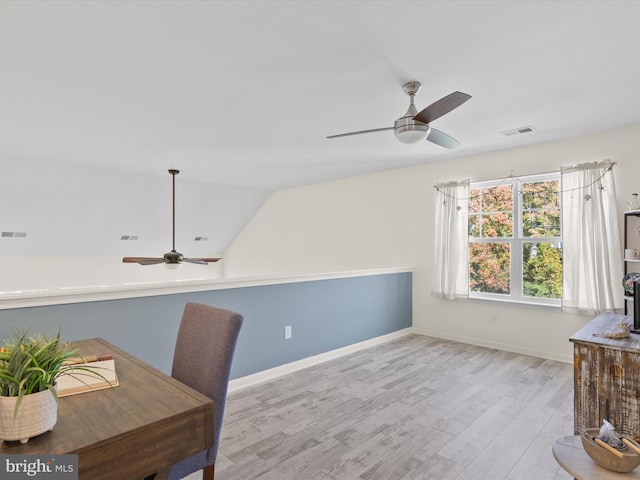 office space featuring light hardwood / wood-style flooring, lofted ceiling, and ceiling fan